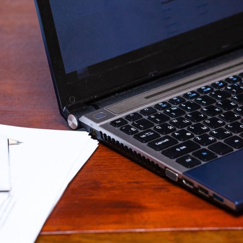 notebook and sheets with records on the desktop